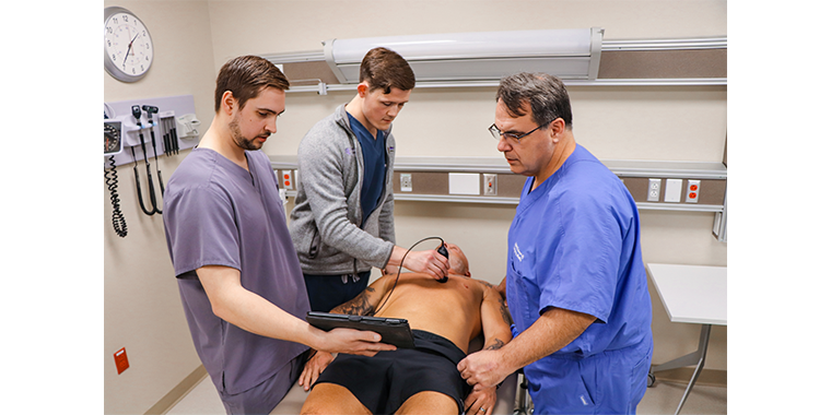 KCU students practicing POCUS with Dr. Arnce 